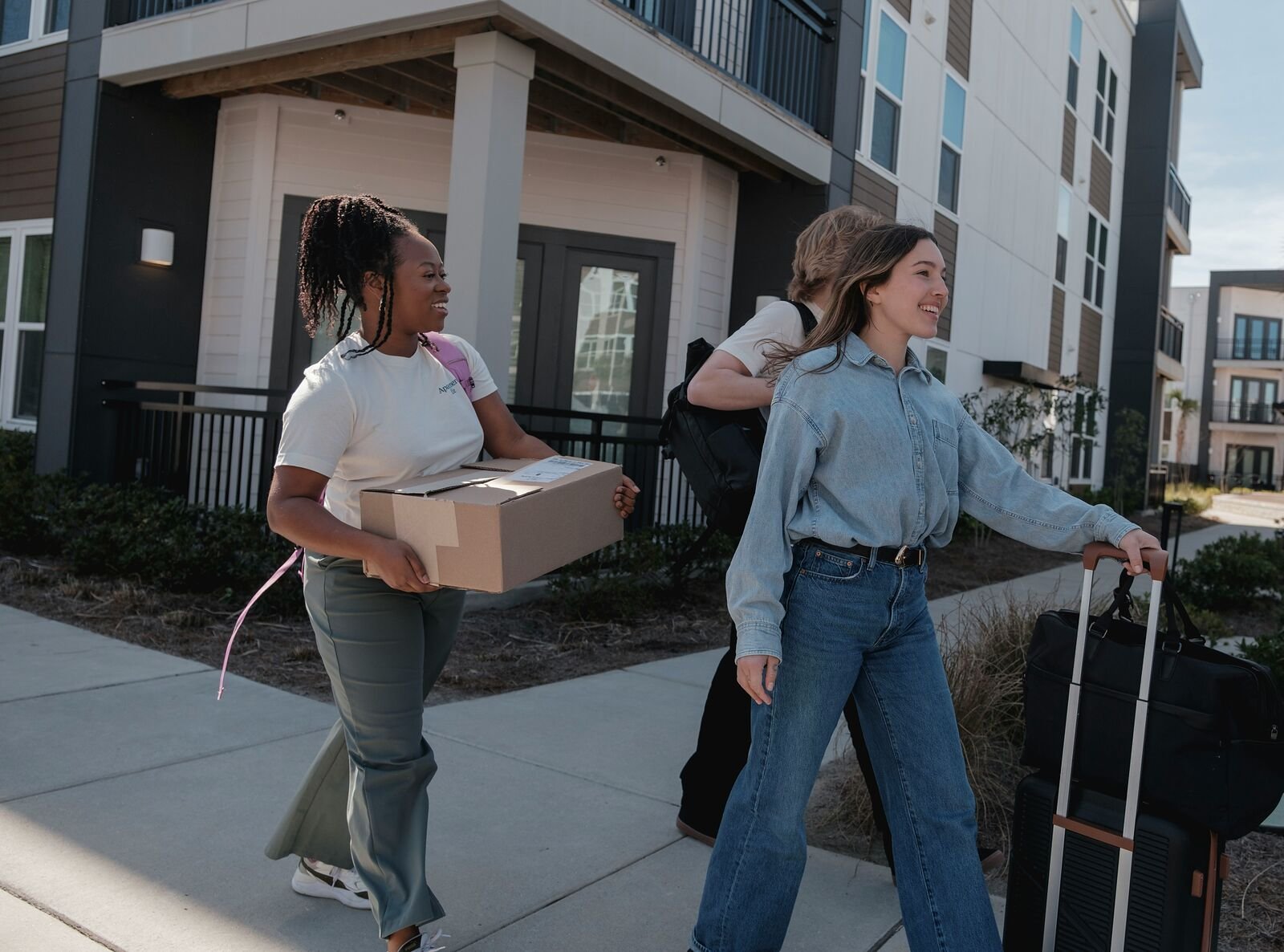 College students carrying moving boxes for summer storage near the University of Dayton